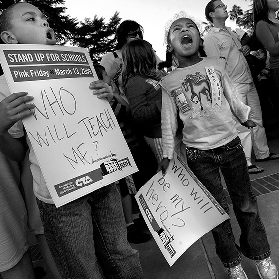 Third grader Devin Bryson, 8, and kindergartener Elizabeth Bryson, 6, both students at Matusuyama Elementary School, shout in support of teachers at the State Capitol in Sacramento, California, on Friday March 13, 2009. Public school teachers gathered outside the Capitol—after school hours—to protest the estimated 25,000 preliminary layoffs of teachers, librarians and other staff statewide due to cuts in education funding. Many demonstrators dressed in pink to call attention to the pink slips. The California Teachers Association blasted the unusually high number of cuts as school districts tinkered with their budgets in hopes of limiting layoffs.