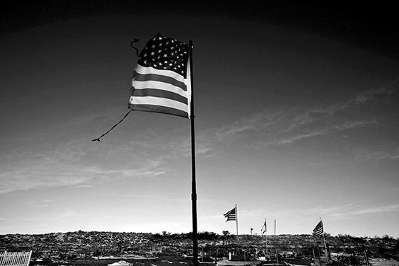 A torn American flag flies over a cemetery in Tuba, Arizona, where Thomasina Nez’s former partner and father to five of her children is buried. The Bennett Freeze ban, instituted in 1966, prohibited home and property improvements on land in Arizona that was disputed by the Navajo and Hopi tribes. The law left 1.5-million acres frozen in bureaucracy until it was reversed in March 2009.