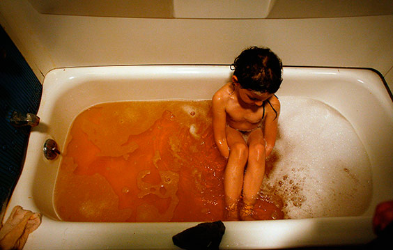 Erica and Rully Urias of Island Creek, Kentucky, bathe their daughter, Makayla, 5, in water containing high levels of arsenic. The family attributes the contamination primarily to the runoff from the mountaintop mines surrounding their home as well as the blasting, which they believe has disrupted the water table and cracked the casing in their well, allowing seepage of heavy metals into the water. The coal company that mines the nearby land has never admitted to causing the problem, but they supply the family with bottled water for drinking and cooking.