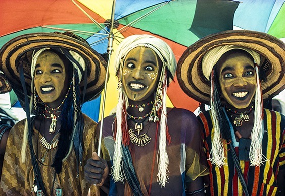 Niger
At the annual Geerewol festival, Wodaabe male charm dancers from Niger perform the competitive Yaake dance. The men lighten their skin with yellow powder, accentuate the length of their noses with a line of pigment and brighten their eyes and teeth with kohl. The men change their facial expressions every few seconds, emphasizing their beautiful teeth and eyes. The winner, in the middle, displays his charisma by holding one eye still while rolling the other from side to side, making him irresistible to the female judges.