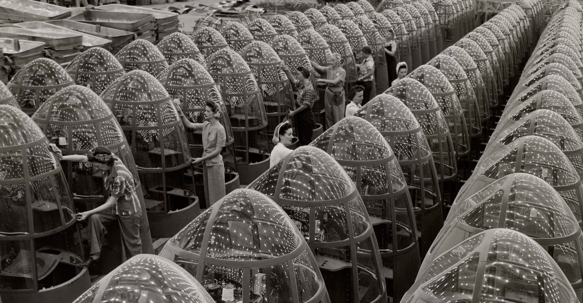 Women aircraft workers finishing transparent bomber noses for fighter and reconnaissance planes at Douglas Aircraft Co. Plant in Long Beach, California 1942